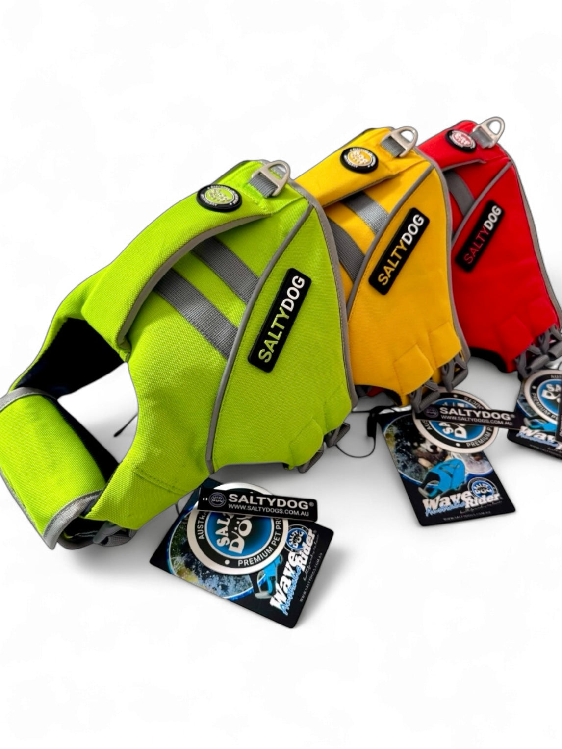 Three dog life vests in green, yellow, and red with 'Salty Dog' branding on a white background.